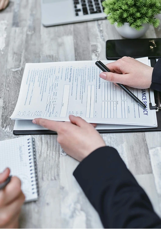 Close up of a policy being handed over to sign